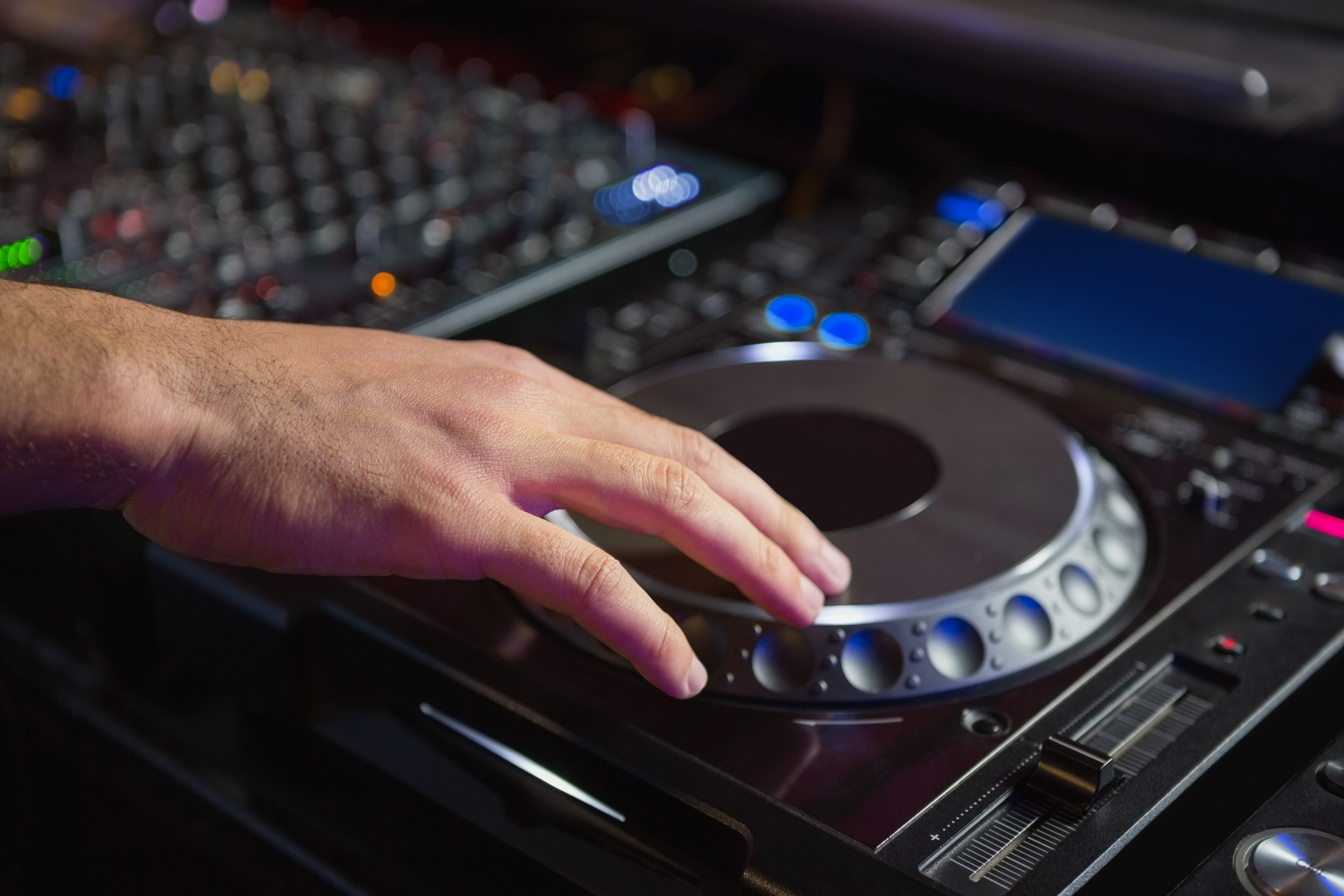 Male DJ playing music at the nightclub